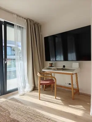 a room with a desk with a tv and a window at Japandi Pearl Designed Studio,Parking ,Aircon, O2 in Prague
