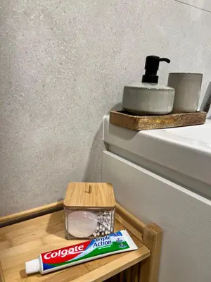 a toothbrush and toothpaste on a wooden table next to a sink at Japandi Pearl Designed Studio,Parking ,Aircon, O2 in Prague