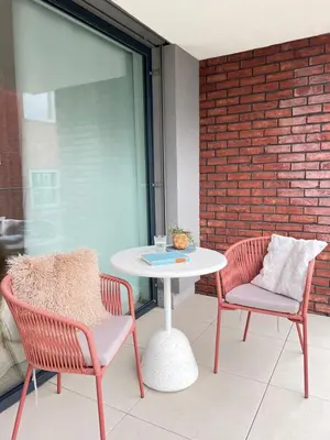 a patio with two chairs and a white table and chairs at Japandi Pearl Designed Studio,Parking ,Aircon, O2 in Prague