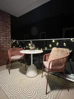 a patio with two chairs and a table on a balcony at Japandi Pearl Designed Studio,Parking ,Aircon, O2 in Prague