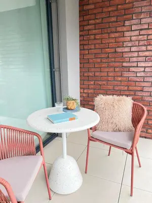 a white table with two chairs and a table with a book at Japandi Pearl Designed Studio,Parking ,Aircon, O2 in Prague
