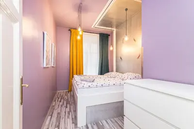 a small bedroom with a bed and a window at Veliant Apartments in Prague