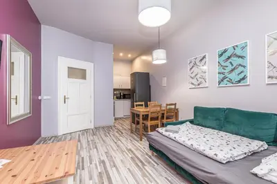 a living room with a green couch and a table at Veliant Apartments in Prague