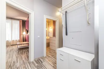 a bathroom with white cabinets and a walk in shower at Veliant Apartments in Prague