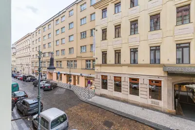 a large building with cars parked in front of it at Veliant Apartments in Prague