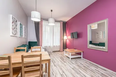 a dining room with purple walls and a dining table at Veliant Apartments in Prague