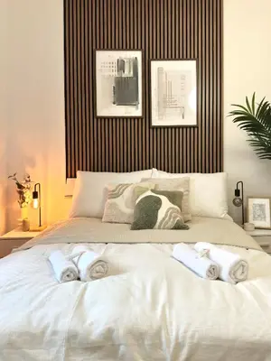 a bedroom with a large bed with towels on it at Rentero Prague Central Apartment in Prague