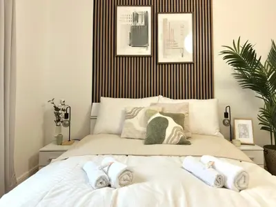 a bedroom with a large bed with towels on it at Rentero Prague Central Apartment in Prague