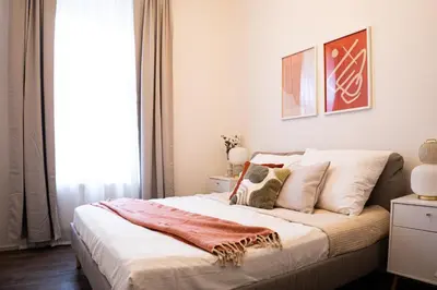 a bedroom with a large bed with white sheets and pillows at Rentero Apartment, 5 min National Muzeum Modern Black Rose in Prague