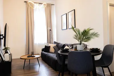 a living room with a couch and a table at Rentero Apartment, 5 min National Muzeum Modern Black Rose in Prague
