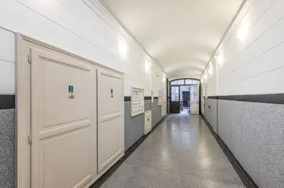 a hallway with white doors in a building at Antiveli Residence in Prague