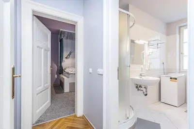 a white bathroom with a sink and a toilet at Antiveli Residence in Prague