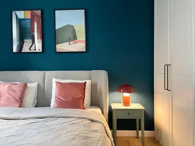 a bedroom with a bed and two pictures on the wall at La casa Prokop in Prague