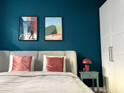 a bedroom with three pictures hanging above a bed at La casa Prokop in Prague