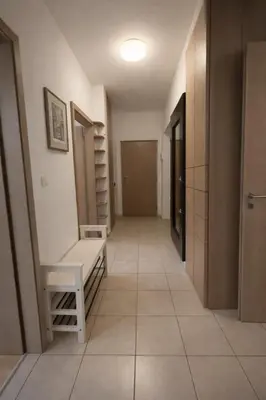 a hallway with a bench and a room with a door at Sauna Apartement, 3 bedrooms, Praha 8 in Prague