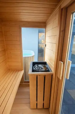 a small stove in a sauna with a window at Sauna Apartement, 3 bedrooms, Praha 8 in Prague