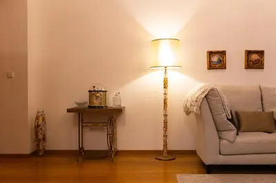 a living room with a lamp and a couch at Staropramenna Garden Residence in Prague