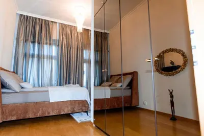a bedroom with a bed and a glass wall at Staropramenna Garden Residence in Prague