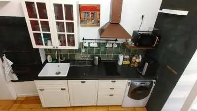 a kitchen with a black counter top and a sink at The Spot Apartment in Prague