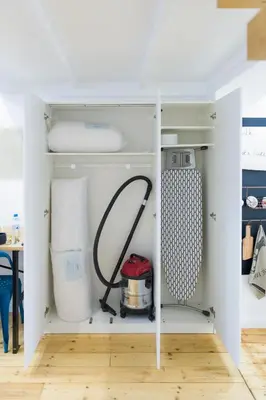 a kitchen with a white cabinet filled with appliances at The Spot Apartment in Prague