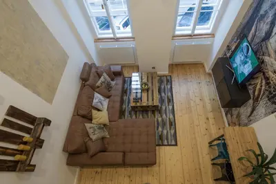 an overhead view of a living room with a couch and a television at The Spot Apartment in Prague