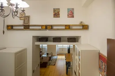 a living room with a shelf on the wall at The Spot Apartment in Prague