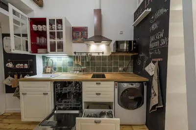 a kitchen with a washer and a dishwasher at The Spot Apartment in Prague