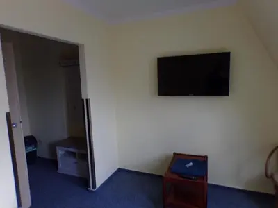 a room with a flat screen tv on the wall at Motel Oseček in Oseček