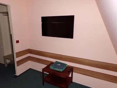 a room with a flat screen tv on the wall at Motel Oseček in Oseček