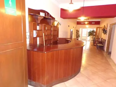 a library with a wooden counter in a room at Motel Oseček in Oseček