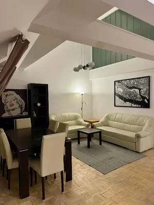 a living room with a table and a couch at Dalimilova Apartments in Prague