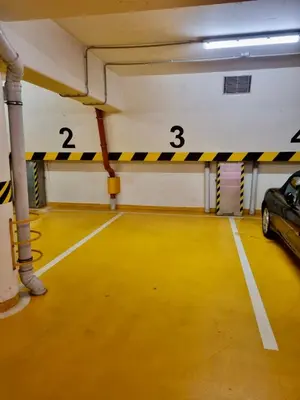 an empty parking garage with a car parked in it at Dalimilova Apartments in Prague