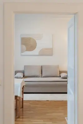 a living room with a couch and a table at Louvre - Cozy City Center Apartment with Balcony in Prague