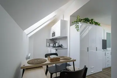 a kitchen and dining room with a table and chairs at Florenc Charming Studio in Prague