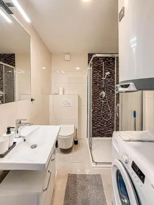 a bathroom with a toilet sink and a shower at Florenc Charming Studio in Prague