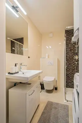 a white bathroom with a sink and a toilet at Florenc Charming Studio in Prague
