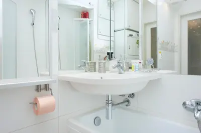 a white bathroom with a sink and a mirror at Best Residence Expo in Prague