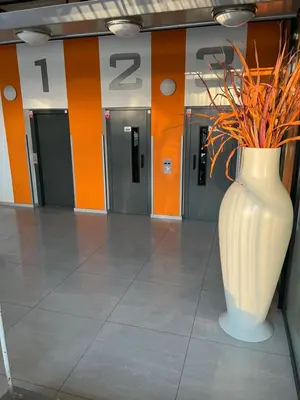a large white vase with flowers in a hallway at Best Residence Expo in Prague