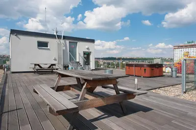 a picnic table and benches on the roof of a building at Best Residence Expo in Prague