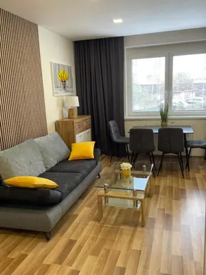a living room with a couch and a table at Aparthotel Praha in Prague