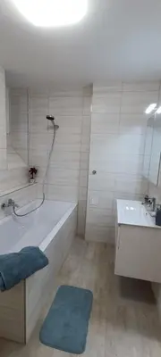 a bathroom with a tub and a sink and a bath tub at Aparthotel Praha in Prague