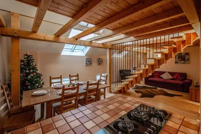 a dining room and living room with a christmas tree at Olives Ruterra Loft with Sauna in Prague