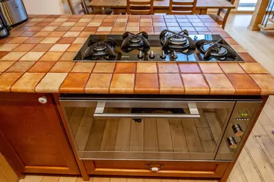 a kitchen island with a stove top oven at Olives Ruterra Loft with Sauna in Prague