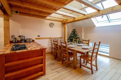a kitchen and dining room with a table and chairs at Olives Ruterra Loft with Sauna in Prague