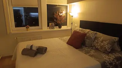 a bedroom with a bed with pillows and a window at Apartmán Pohoda in Prague