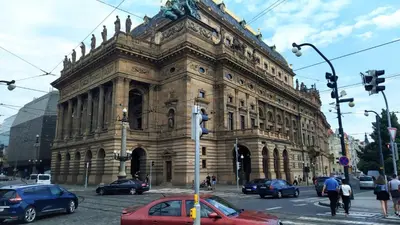 a large building with cars parked in front of it at Apartmán Pohoda in Prague