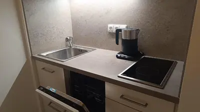 a small kitchen with a sink and a counter top at Apartmán Pohoda in Prague