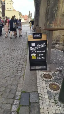 a sign sitting on the side of a street at Apartmán Pohoda in Prague