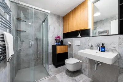 a bathroom with a shower and a toilet and a sink at Prague Days - Studio with Terrace and Garage in Modern Building in Prague