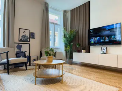 a living room with a large tv on a wall at 100m2 Wenceslas Comfort, 3BDR with Netflix in Prague